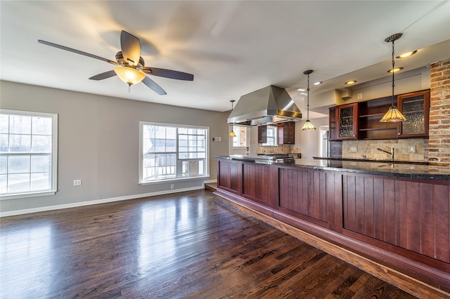 kitchen with decorative light fixtures, decorative backsplash, dark hardwood / wood-style flooring, and island range hood