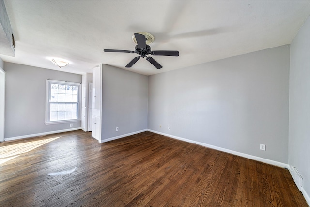 unfurnished room with dark wood-type flooring and ceiling fan