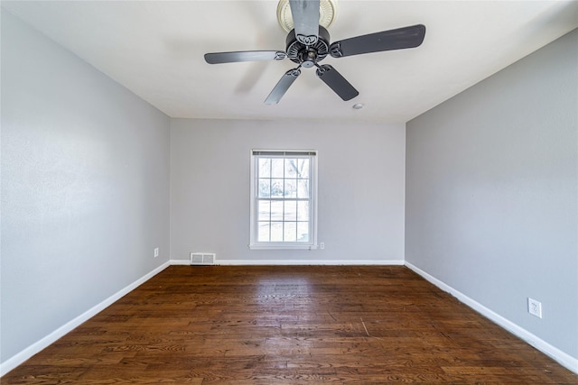 empty room featuring ceiling fan and dark hardwood / wood-style floors