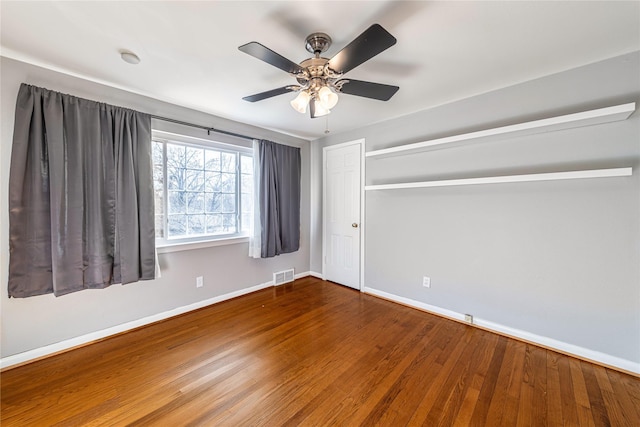 spare room featuring ceiling fan and hardwood / wood-style flooring