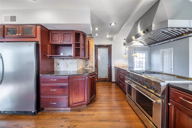 kitchen featuring pendant lighting, decorative backsplash, stainless steel appliances, dark hardwood / wood-style flooring, and island range hood