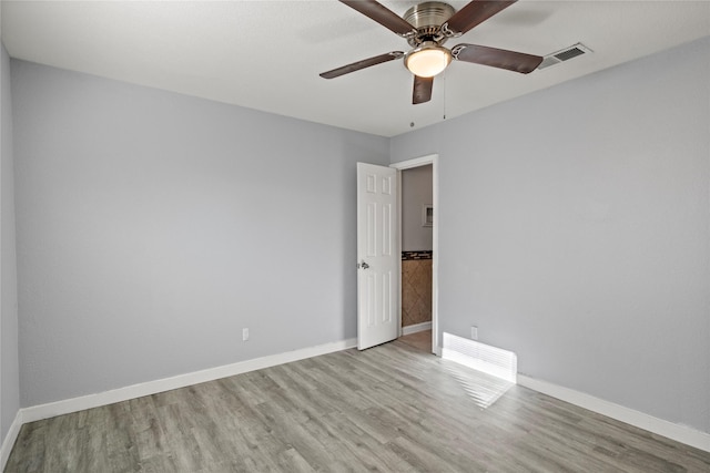 empty room featuring ceiling fan and light hardwood / wood-style flooring