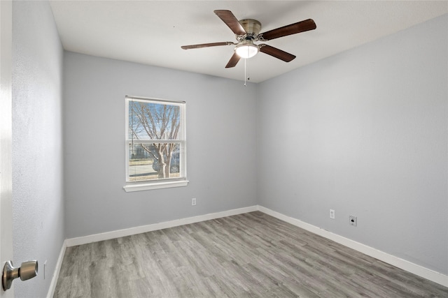 empty room with ceiling fan and light hardwood / wood-style flooring