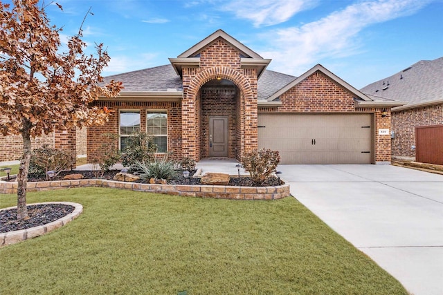 view of front of home with a garage and a front yard