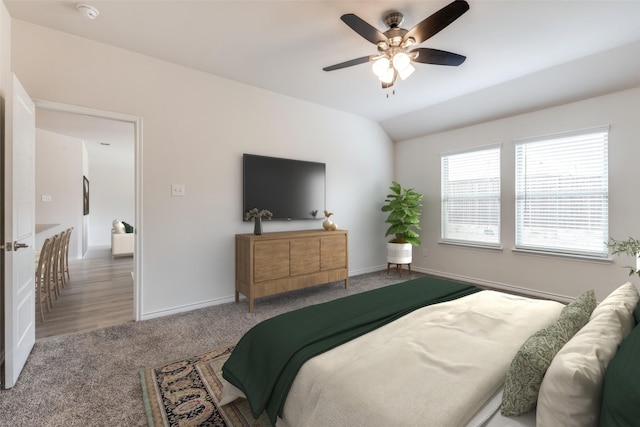 carpeted bedroom featuring ceiling fan and vaulted ceiling