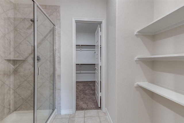 bathroom featuring tile patterned flooring and walk in shower