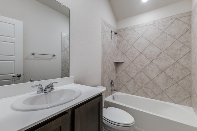 full bathroom with tiled shower / bath combo, vanity, lofted ceiling, and toilet