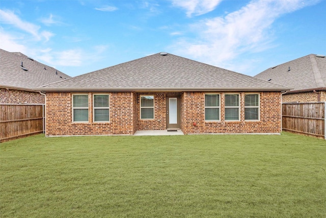 back of house with a patio area and a lawn