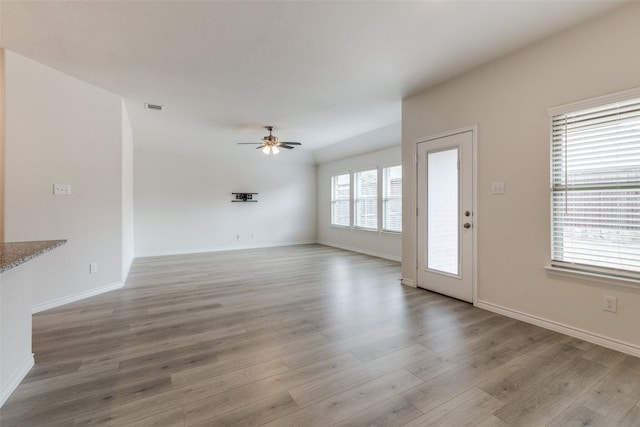 unfurnished living room with ceiling fan and light hardwood / wood-style floors