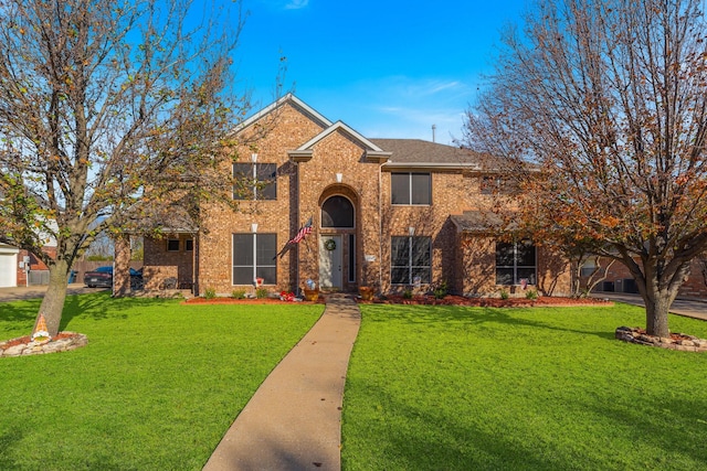 traditional-style house with a front lawn and brick siding