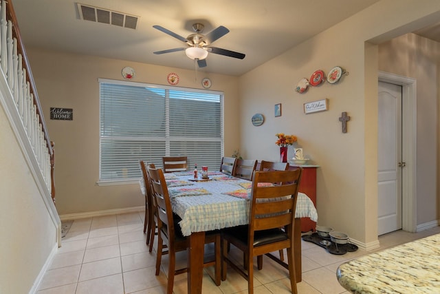 tiled dining area featuring ceiling fan