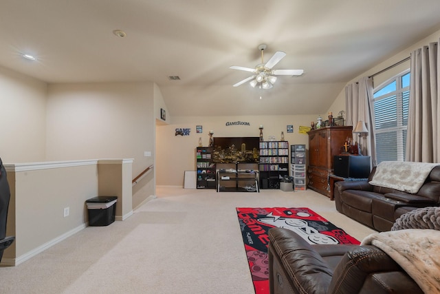 carpeted living room featuring ceiling fan and lofted ceiling