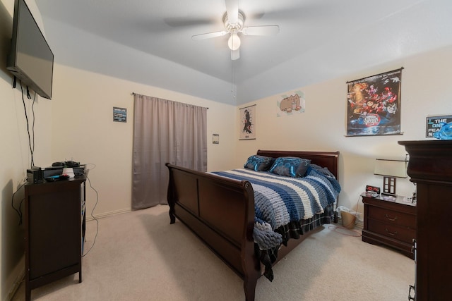 bedroom featuring ceiling fan, light carpet, and vaulted ceiling