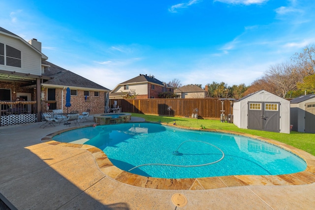 view of swimming pool featuring a shed, an in ground hot tub, and a patio