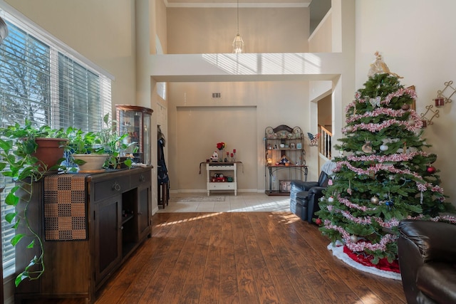 entryway with a towering ceiling and light hardwood / wood-style floors