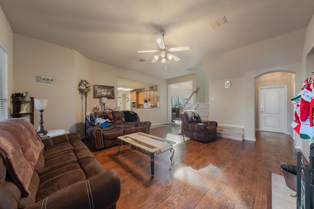 living room featuring ceiling fan and dark hardwood / wood-style flooring