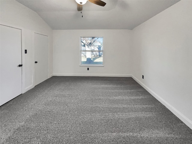 interior space with vaulted ceiling, ceiling fan, and carpet