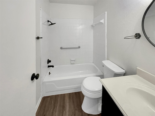 full bathroom featuring toilet, vanity, wood-type flooring, and bathing tub / shower combination