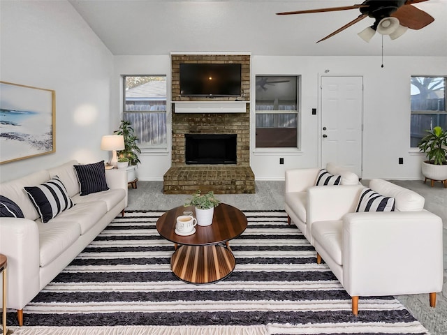 living room featuring carpet floors, ceiling fan, and a fireplace