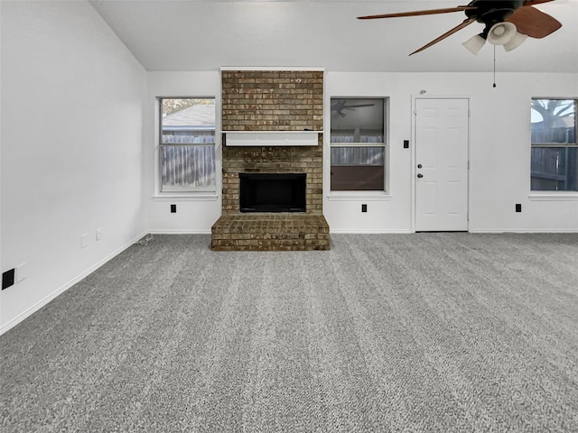 unfurnished living room with carpet, ceiling fan, and a fireplace