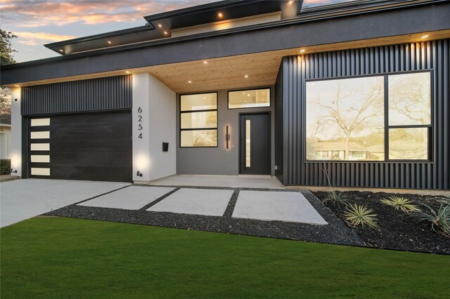 contemporary house with a front yard and a garage