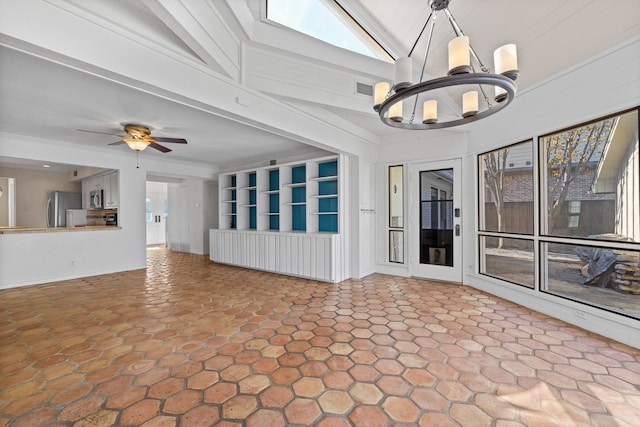 unfurnished living room with ceiling fan with notable chandelier and high vaulted ceiling