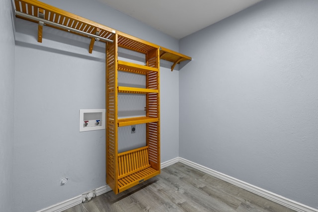 clothes washing area featuring hookup for a gas dryer, washer hookup, electric dryer hookup, and hardwood / wood-style floors