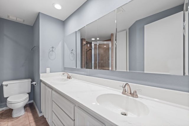 bathroom featuring toilet, tile patterned floors, walk in shower, and vanity