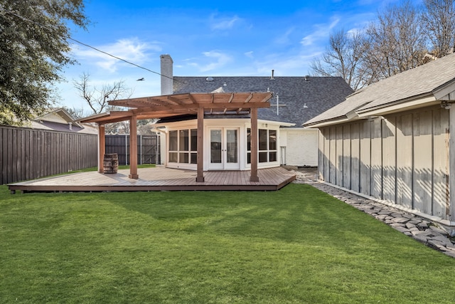 back of property featuring a yard, a pergola, a wooden deck, and a sunroom