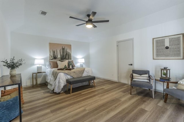 bedroom with ceiling fan and wood-type flooring