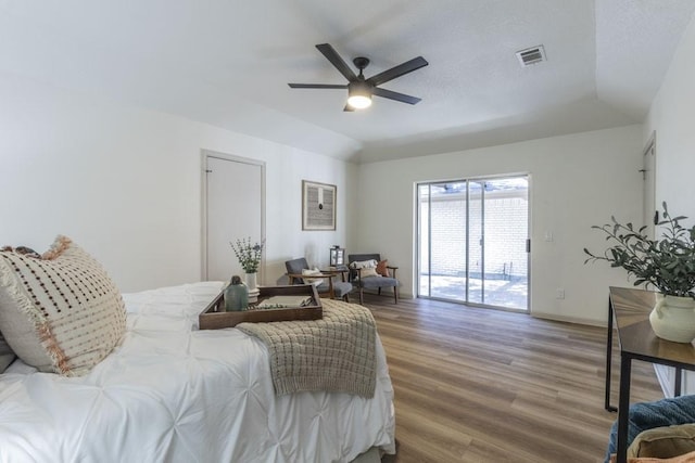 bedroom featuring ceiling fan, lofted ceiling, access to exterior, and wood-type flooring