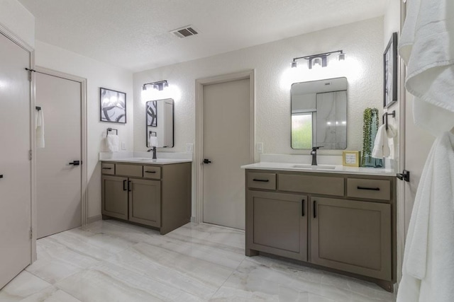 bathroom with a textured ceiling and vanity