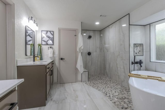 bathroom featuring vanity and independent shower and bath