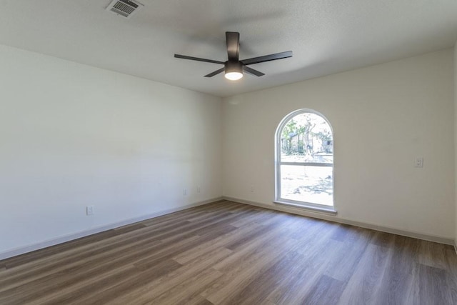 empty room featuring a textured ceiling, ceiling fan, and hardwood / wood-style floors