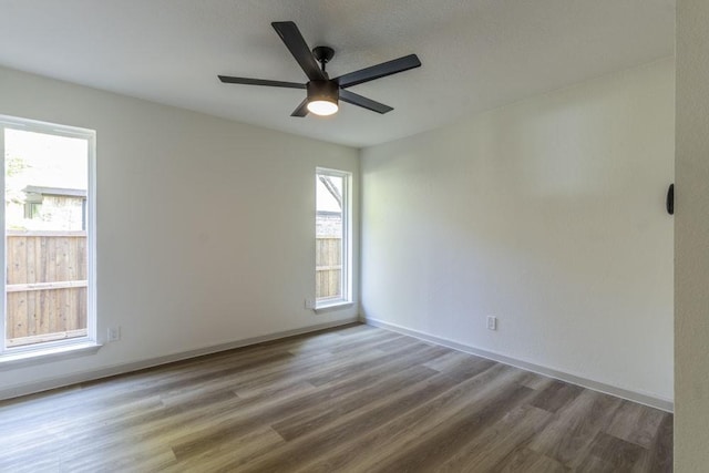 unfurnished room with hardwood / wood-style flooring and ceiling fan