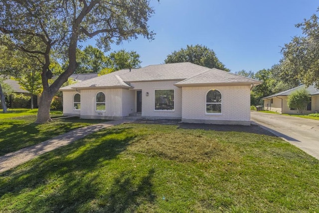 ranch-style home with a front lawn