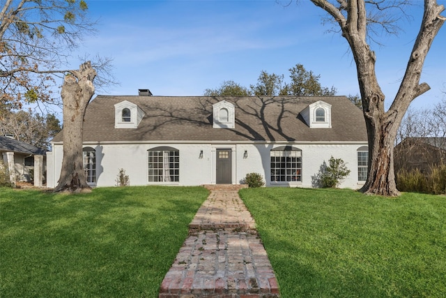 cape cod house featuring a front lawn