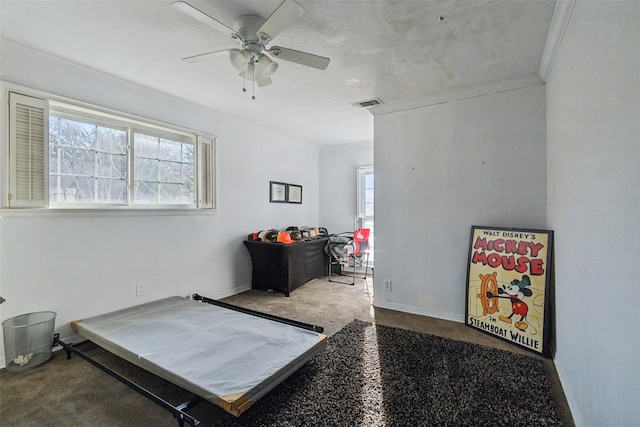 interior space with ceiling fan and crown molding