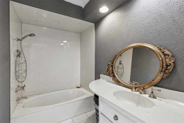 bathroom featuring tile patterned floors, a bathtub, and vanity