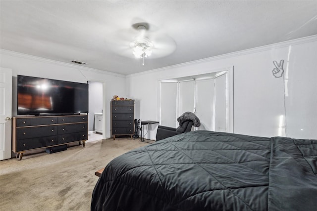 carpeted bedroom with ceiling fan and ornamental molding