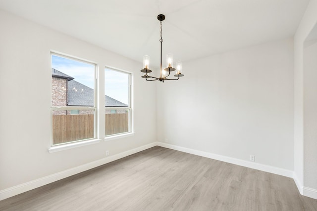 1233 Sylvia St, Desoto, TX 75115 - spare room with light wood finished floors, a chandelier, and baseboards