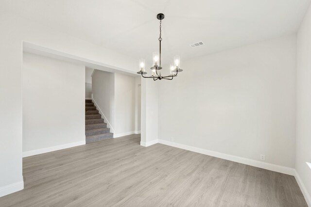 1233 Sylvia St, Desoto, TX 75115 - empty room featuring a chandelier, light wood-style floors, stairway, and baseboards