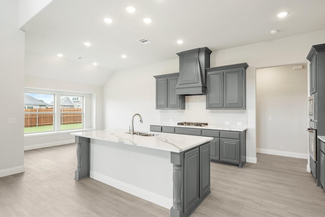 1233 Sylvia St, Desoto, TX 75115 - kitchen with custom exhaust hood, a sink, gray cabinets, stainless steel appliances, and backsplash