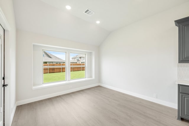 1233 Sylvia St, Desoto, TX 75115 - unfurnished living room with light wood finished floors, lofted ceiling, baseboards, and recessed lighting