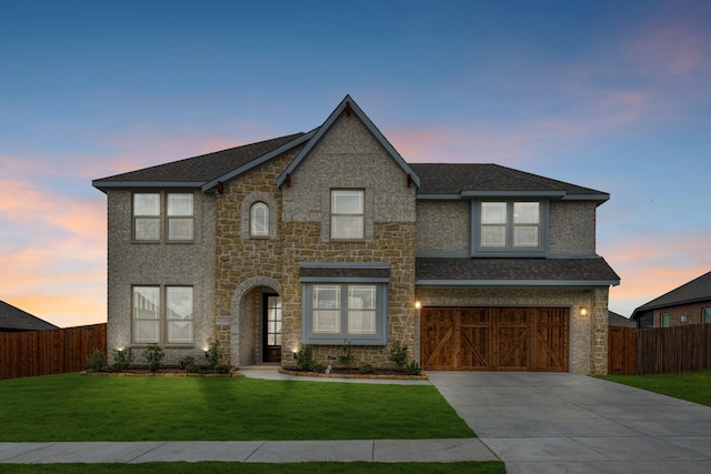 1233 Sylvia St, Desoto, TX 75115 - view of front of house featuring stone siding, driveway, an attached garage, and roof with shingles