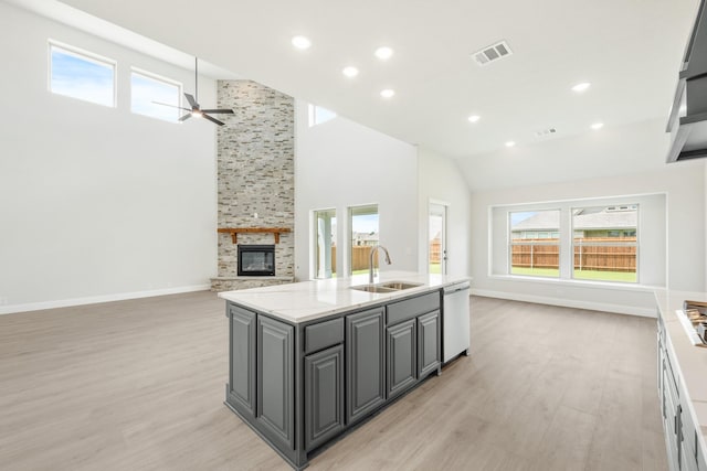 1233 Sylvia St, Desoto, TX 75115 - kitchen with a sink, open floor plan, stainless steel dishwasher, light wood finished floors, and high vaulted ceiling