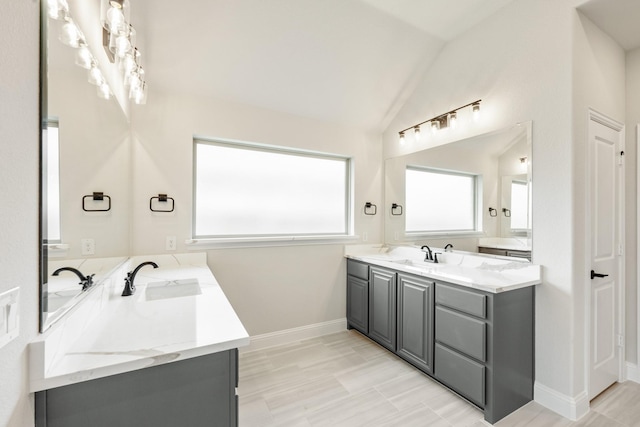 1233 Sylvia St, Desoto, TX 75115 - bathroom with double vanity, vaulted ceiling, and baseboards