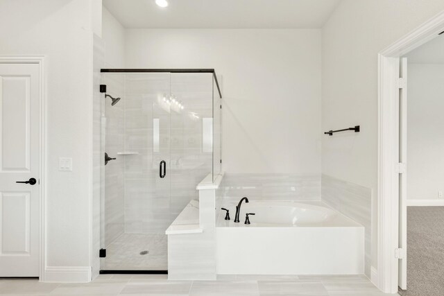 1233 Sylvia St, Desoto, TX 75115 - bathroom with a garden tub, a shower stall, and baseboards