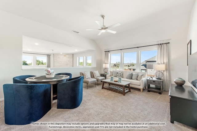 carpeted living room with ceiling fan and lofted ceiling