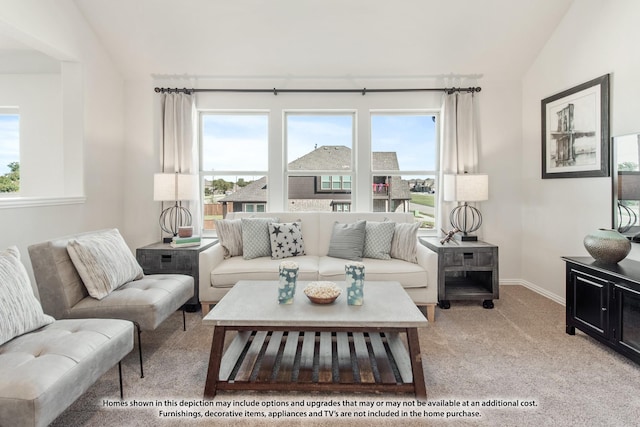 living room with plenty of natural light, light colored carpet, and lofted ceiling